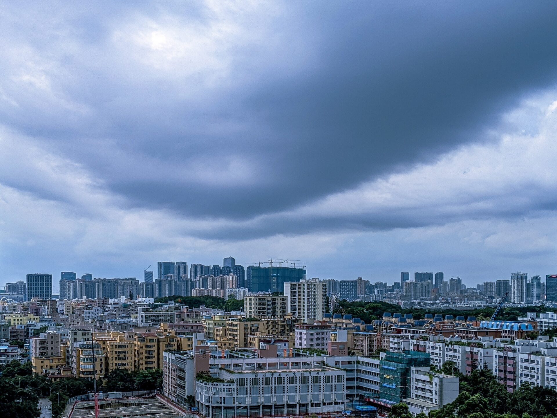Great shot of a modern city and a sky full of dark clouds