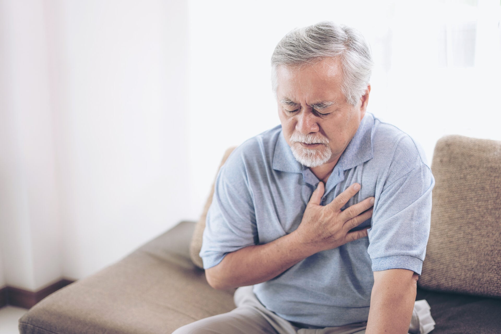 senior-male-asian-suffering-from-bad-pain-his-chest-heart-attack-home