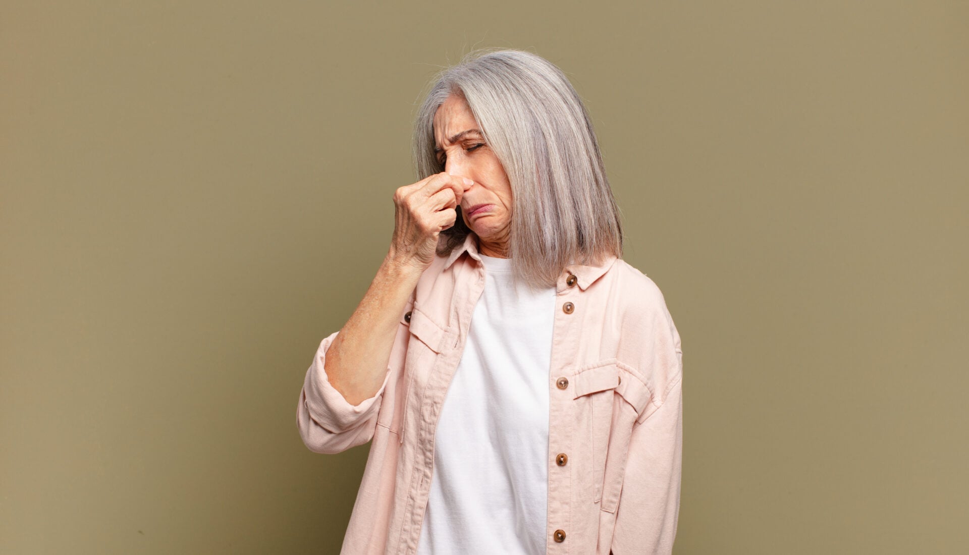 feeling disgusted, holding nose to avoid smelling a foul and unpleasant stench