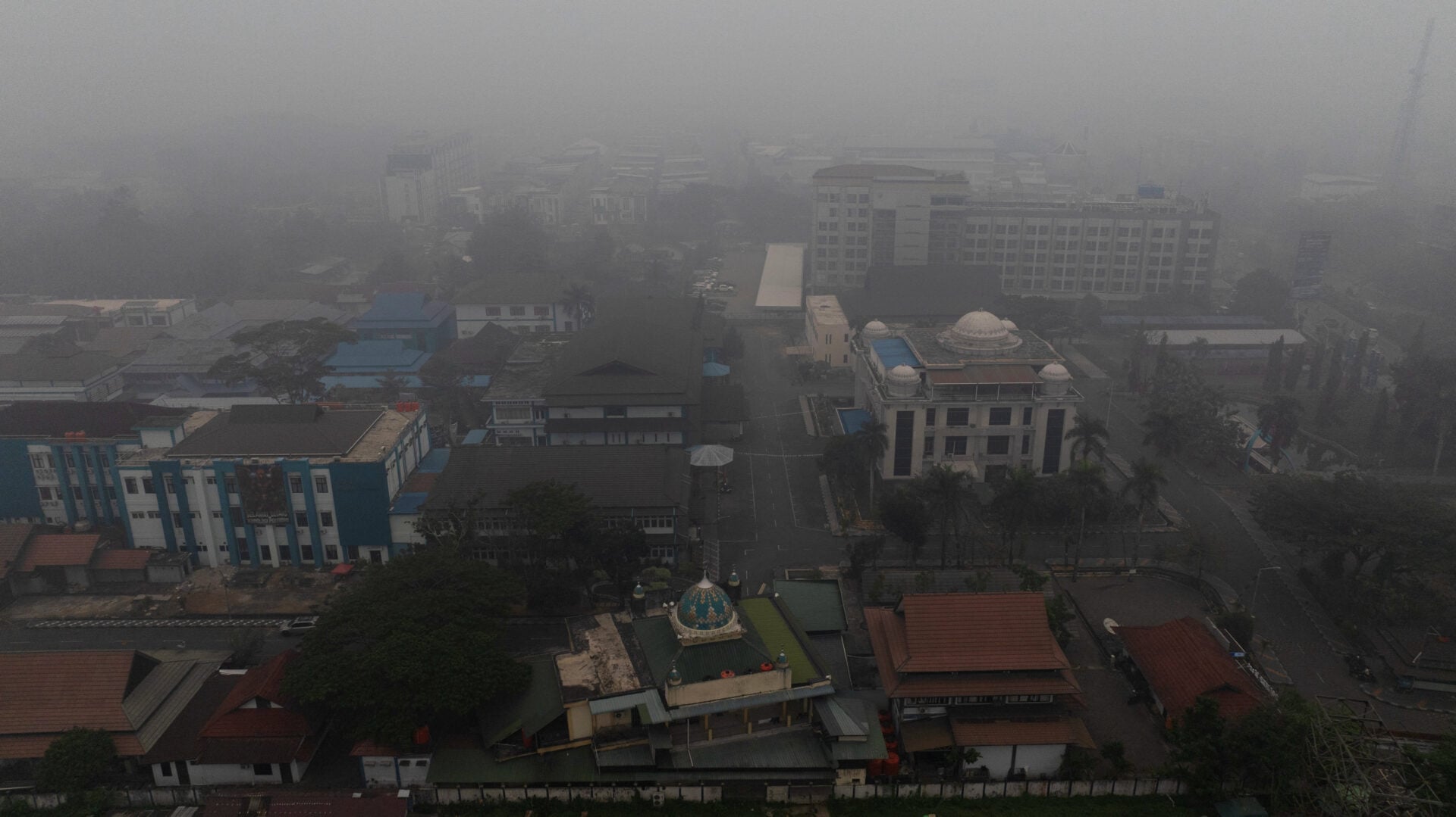 A drone view shows buildings shrouded in haze from wildfires in Pontianak