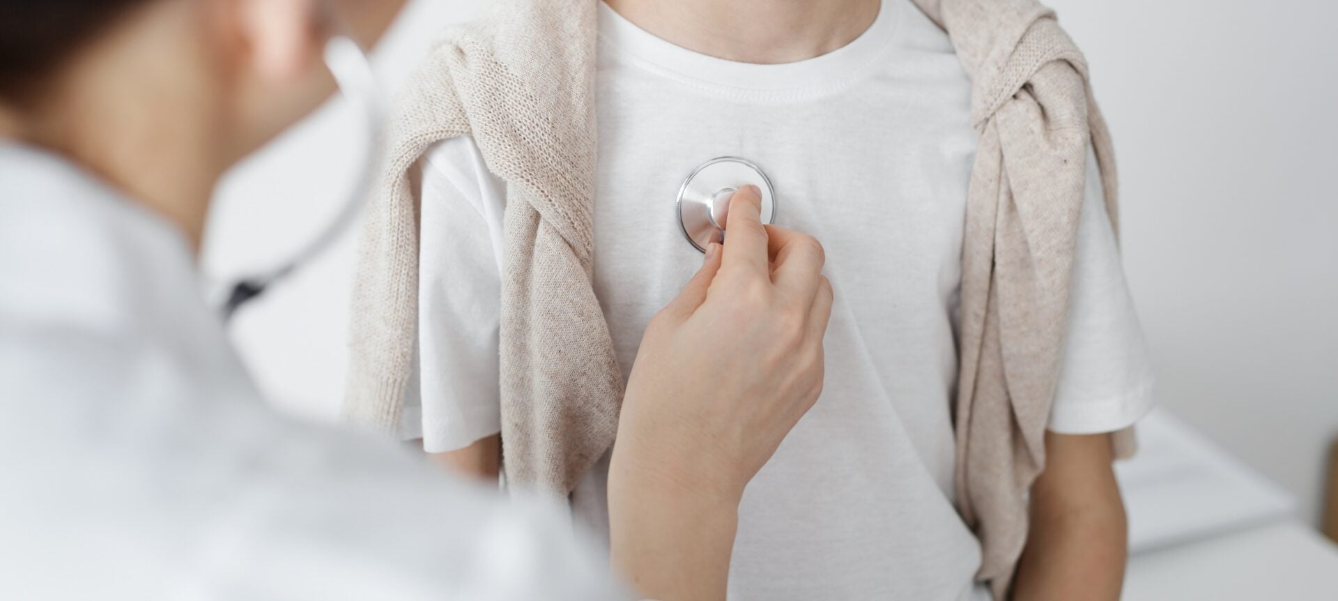 Doctor is examining a kid patient with a stethoscope. Perfect health concept in medicine