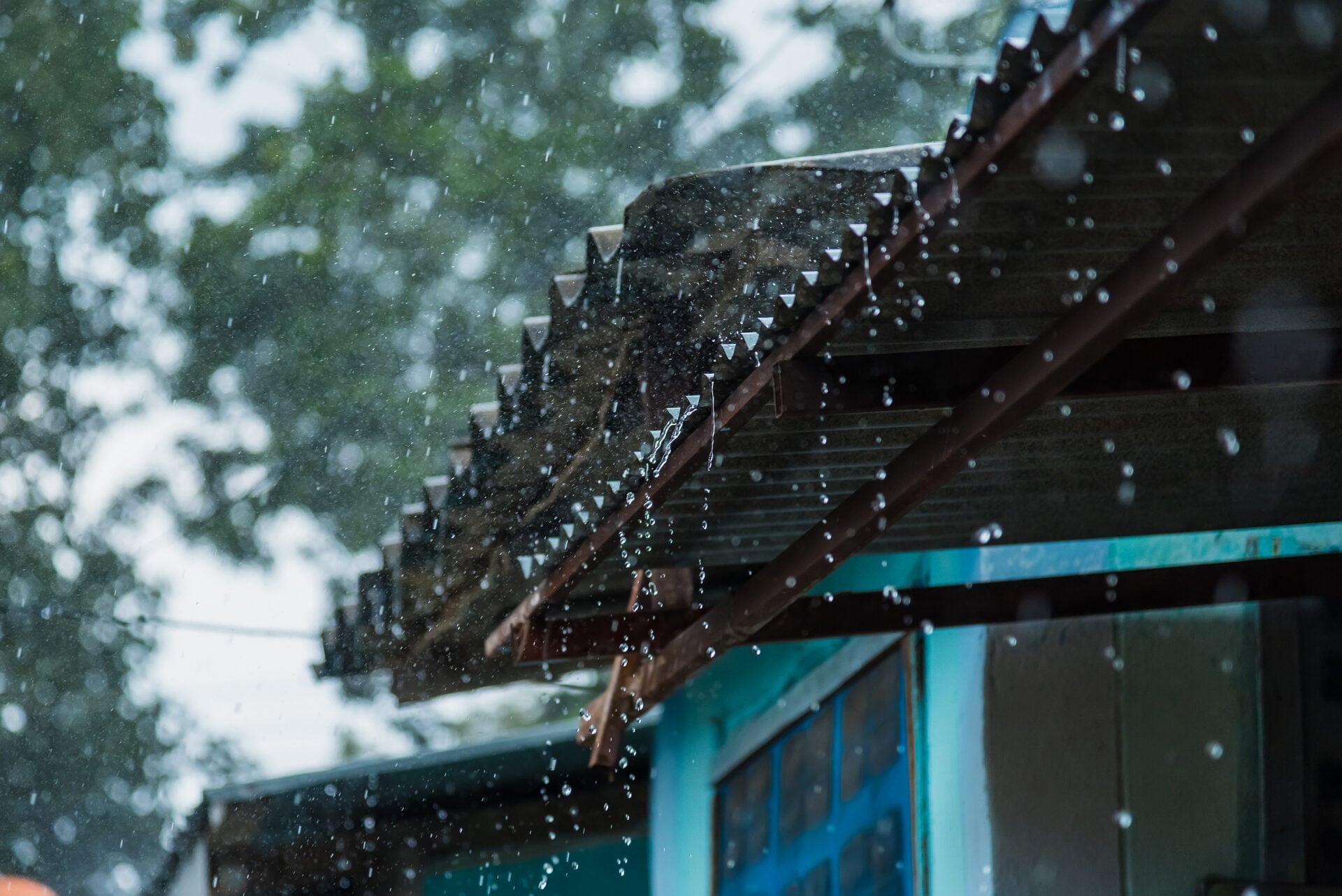 Rain storm with metal sheet roof,rainwater flows down the roof.